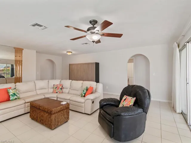 Living room featuring ceiling fan and light tile patterned floors