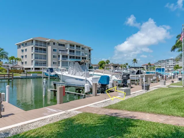 Dock area with a water view and a lawn