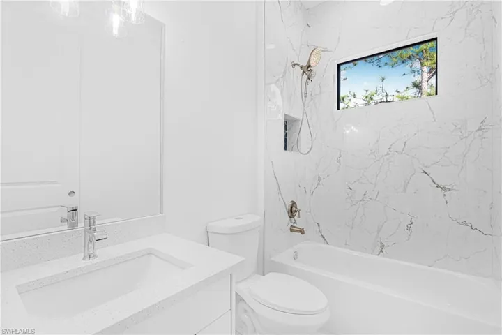 Bathroom with vanity and shower / tub combination