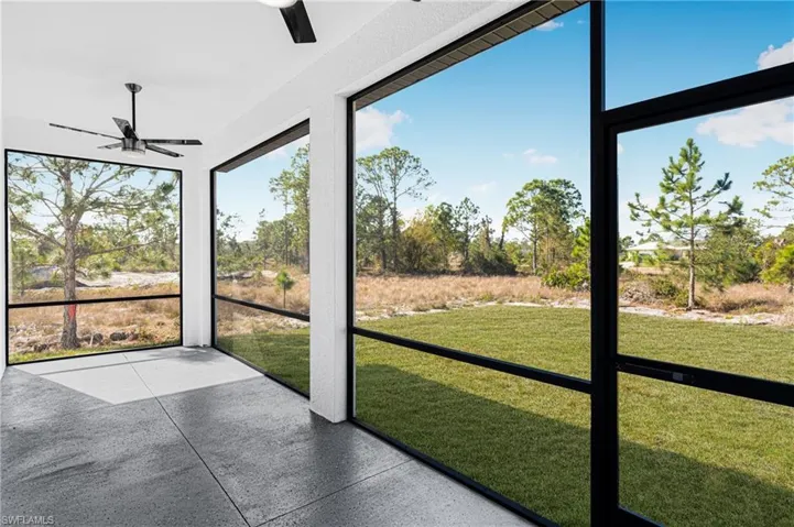 Unfurnished sunroom featuring ceiling fan