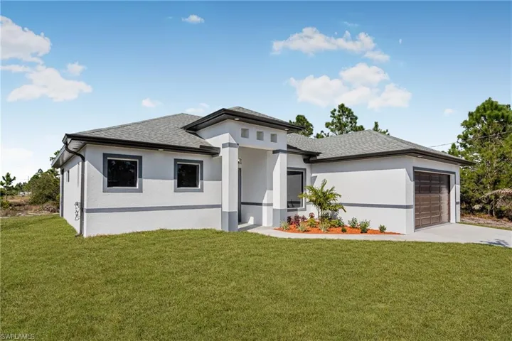 Prairie-style home with an attached garage, roof with shingles, stucco siding, and a front yard