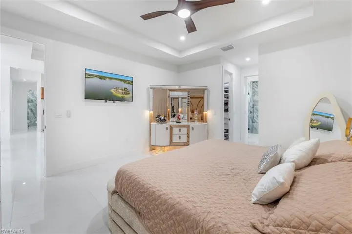 Spacious room featuring white tile flooring, recessed lighting, and a ceiling fan
