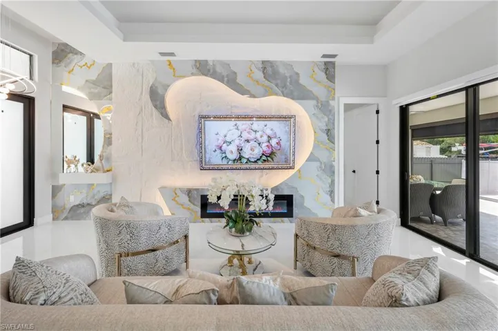 Statement wall featuring marble-finish paneling and an integrated fireplace