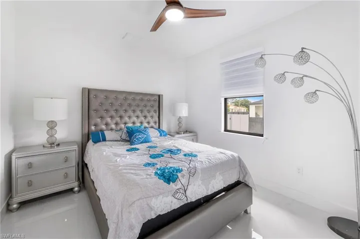 Bright interior room featuring a wood-finish ceiling fan, recessed lighting, and a window with horizontal blinds
