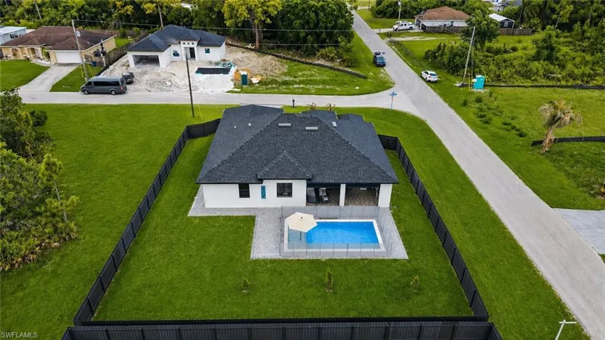 Modern single-story residence featuring a dark shingle roof and white stucco exterior