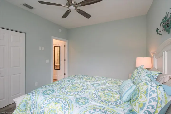 Bedroom with ceiling fan and a closet