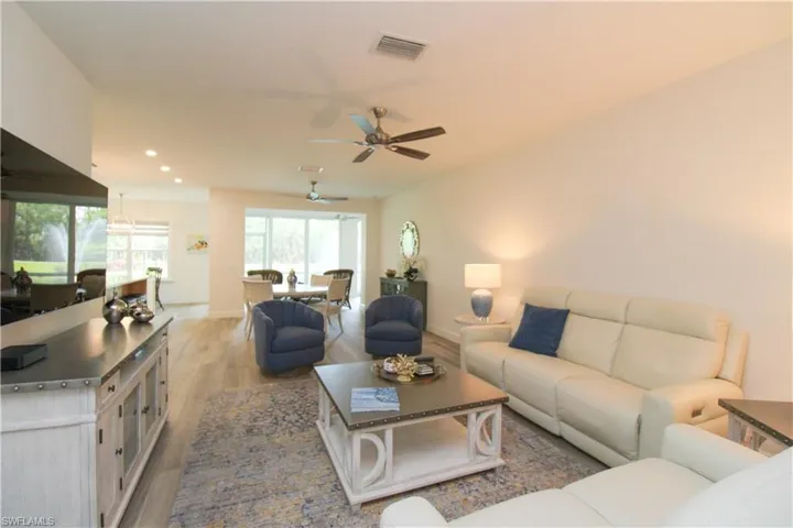 Living room with hardwood / wood-style floors and ceiling fan