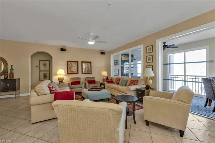 Living room featuring ceiling fan and light tile patterned flooring