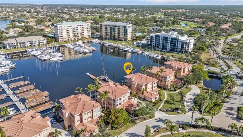 Birds eye view of property with a water view