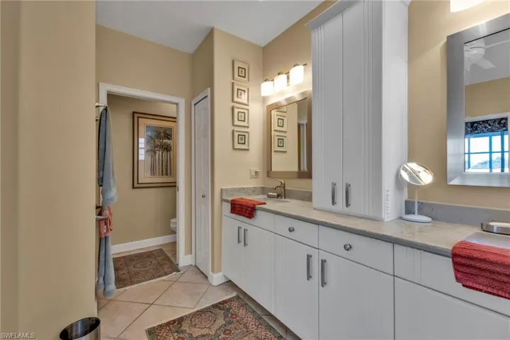 Bathroom with tile patterned flooring, vanity, and toilet