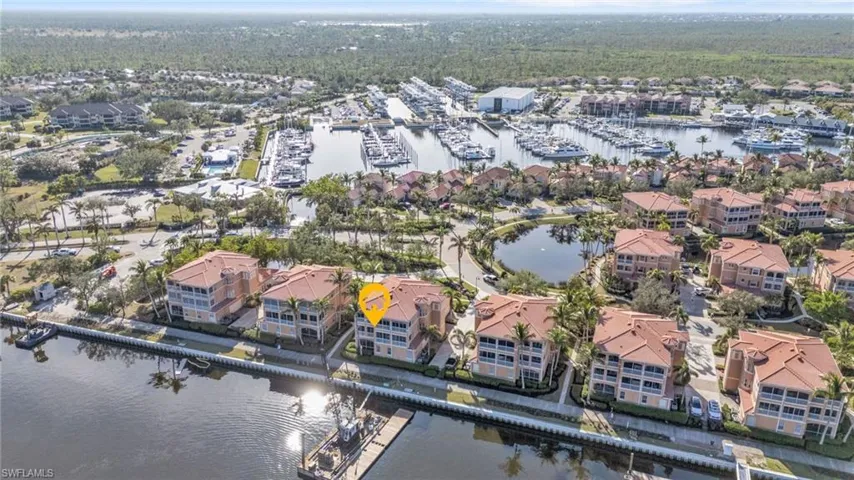 Birds eye view of property with a water view