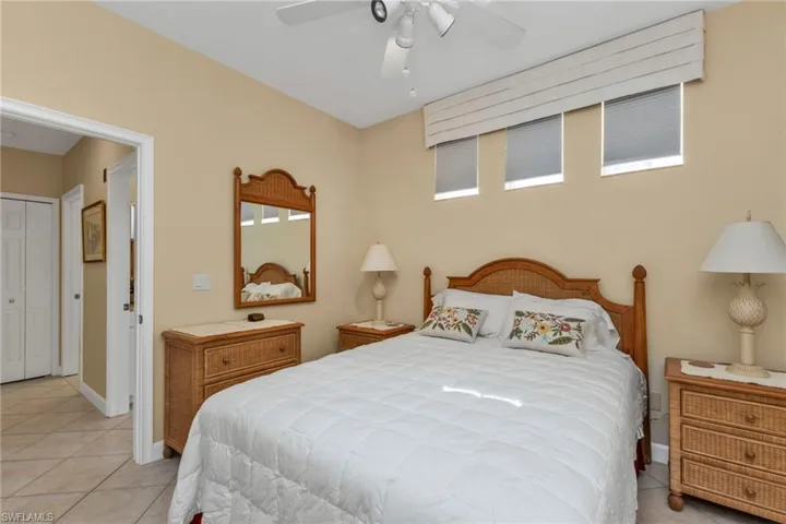 Tiled bedroom with a closet and ceiling fan