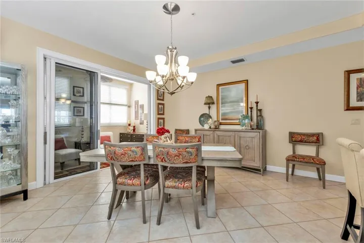 Dining room featuring a notable chandelier and light tile patterned flooring