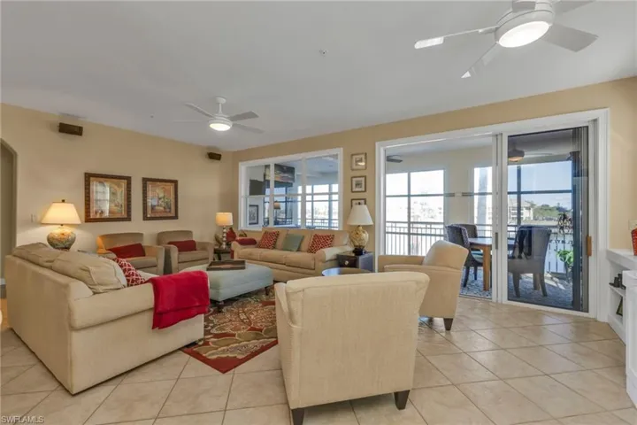 Living room featuring ceiling fan and light tile patterned flooring