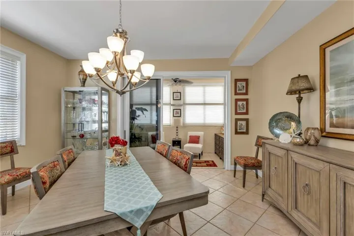 Tiled dining space with a notable chandelier