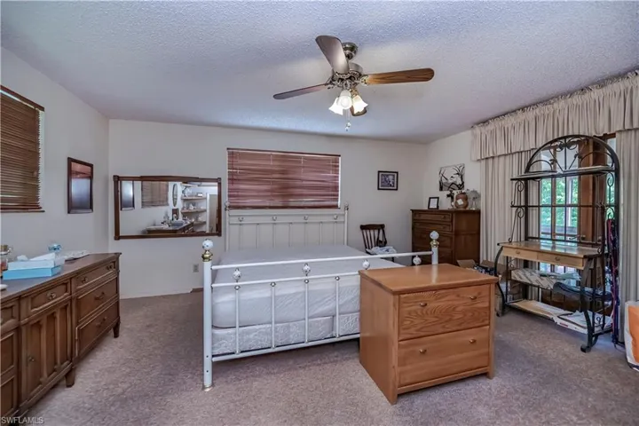 Carpeted bedroom with a textured ceiling