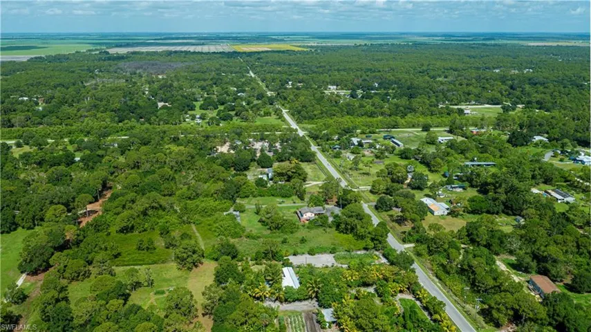 Aerial view of property and surrounding area featuring a heavily wooded area