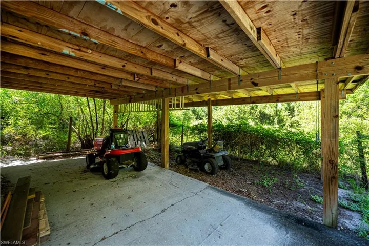 View of patio with a carport