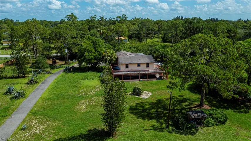View of subject property with a forest