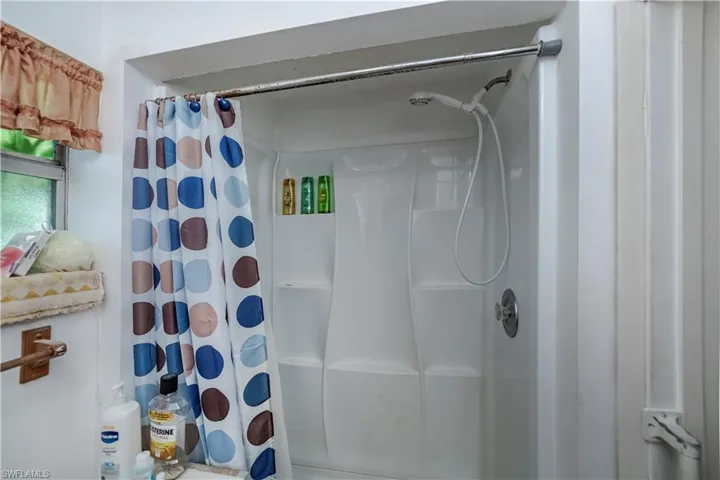 Bathroom featuring curtained shower