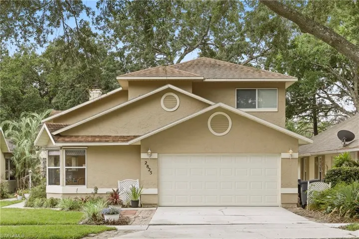 Two-story stucco exterior with a prominent two-car garage