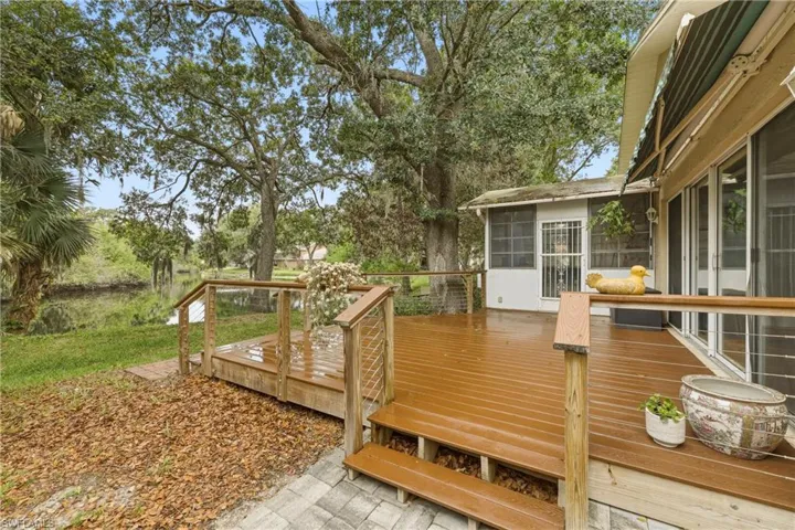Spacious rear deck featuring warm-toned wood-finish planks and cable railings