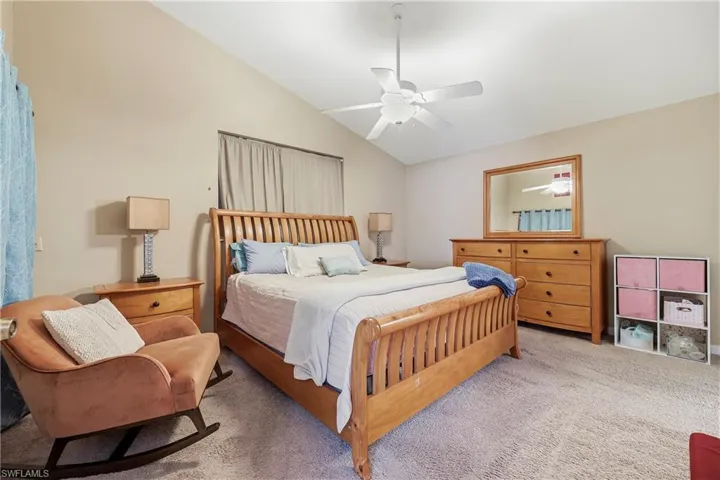 Bedroom with vaulted ceiling and ceiling fan