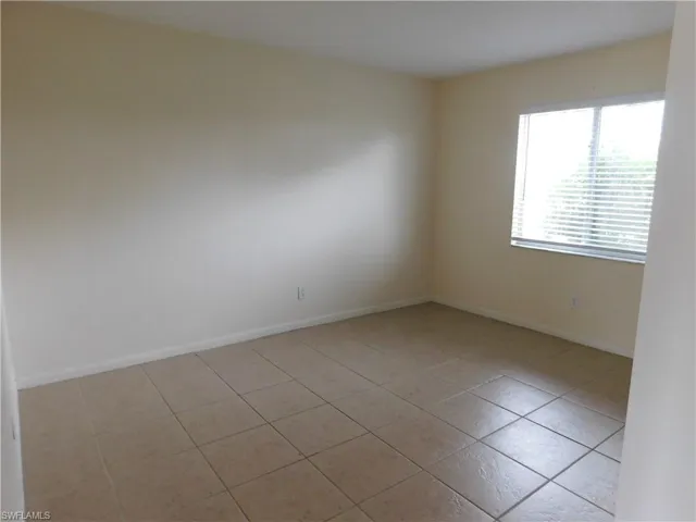 Master bedroom has large tile flooring and north facing window