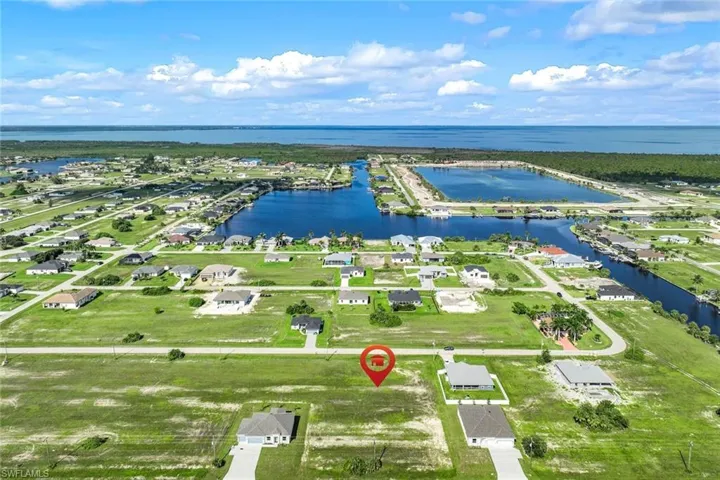 Birds eye view of property with a water view