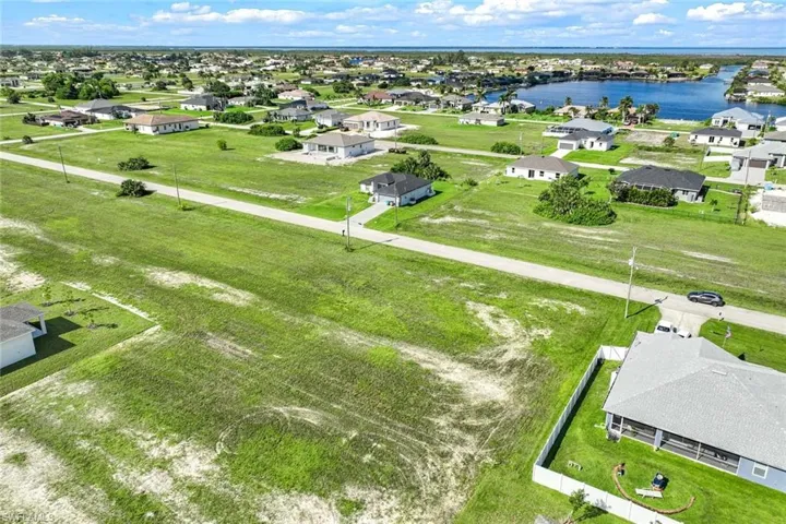 Birds eye view of property with a water view