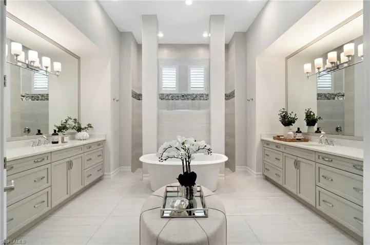 Primary oasis with dual vanities, walk in shower and large soaking tub