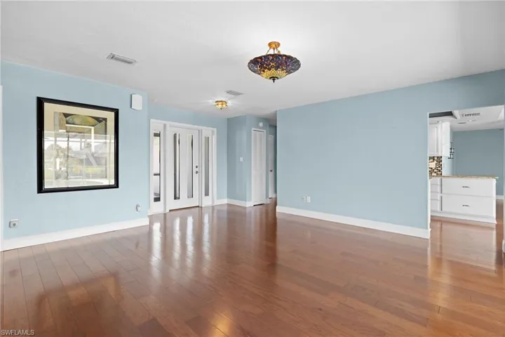 Empty room with dark hardwood / wood-style floors