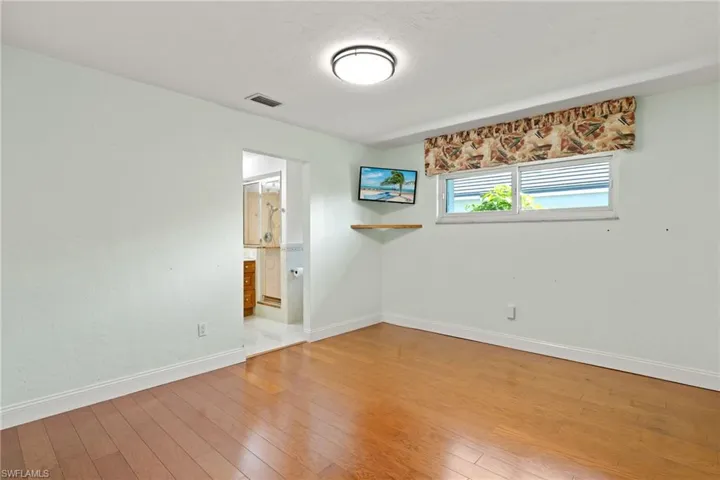 Unfurnished room with hardwood / wood-style flooring