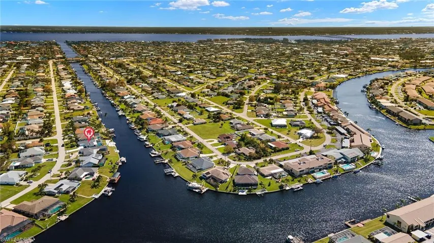 Birds eye view of property with a water view