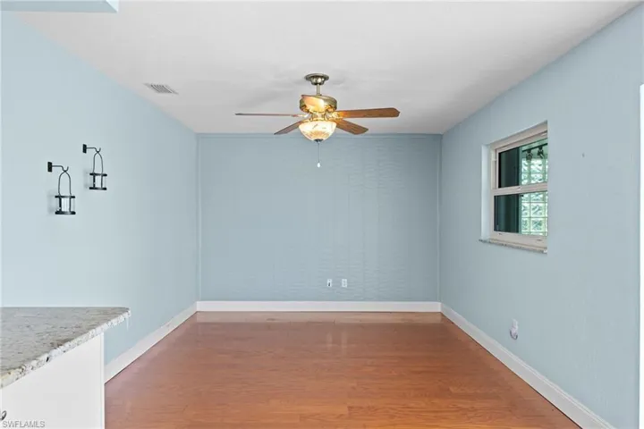 Unfurnished dining area with wood-type flooring and ceiling fan