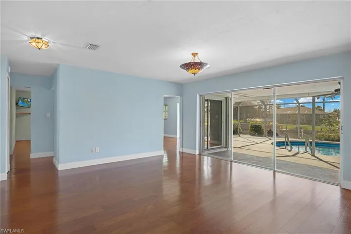 Empty room featuring dark hardwood / wood-style flooring