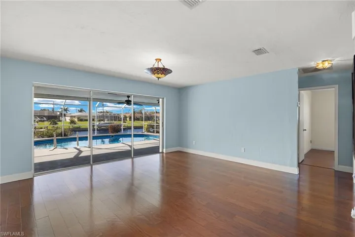 Empty room featuring dark hardwood / wood-style flooring