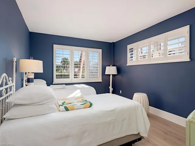 Bedroom featuring wood finished floors and baseboards