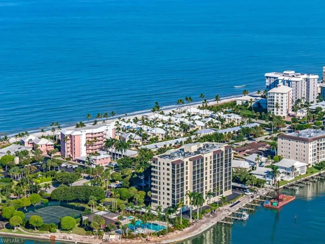 Aerial view of property and surrounding area with a large body of water and apartment complex