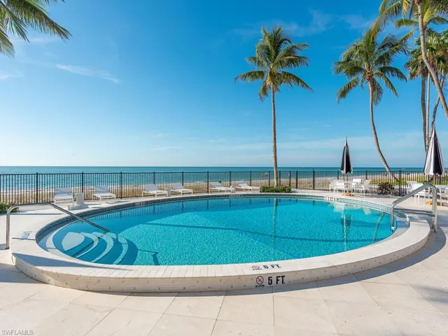 Community pool featuring a patio and a water view