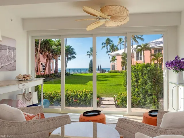 Sunroom featuring healthy amount of natural light and a water view