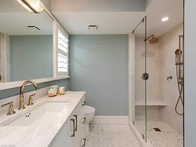 Full bath with vanity, a shower stall, and recessed lighting