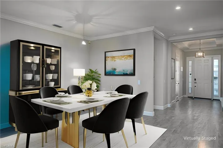 Virtually Staged Dining area featuring wood-type flooring and crown molding