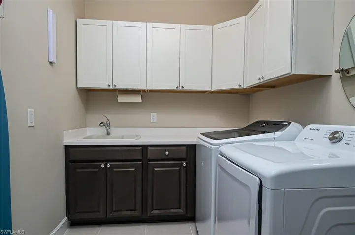 Laundry room off the garage. Extra storage, sink, washer and dryer