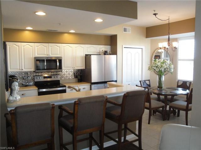 High top Breakfast bar and eat-in kitchen with new stainless appliances, solid surface counters and raised white panel cabinets.