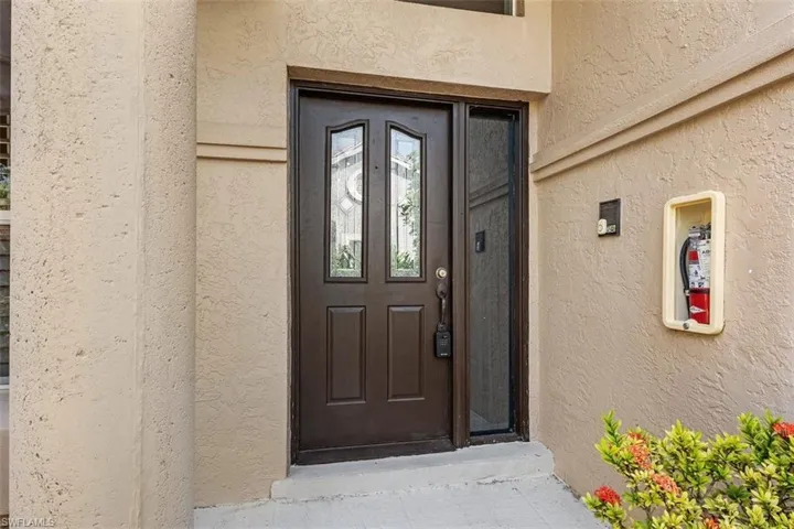 Doorway to property with stucco siding