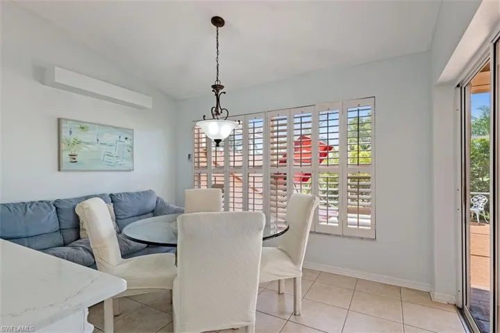 Dining space featuring vaulted ceiling and light tile patterned floors