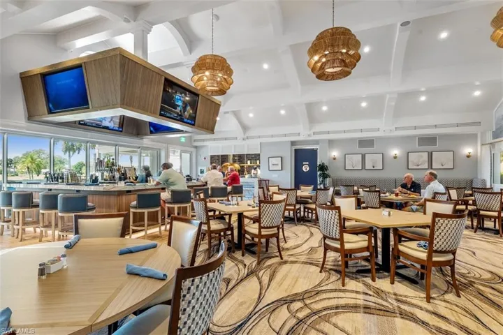 Dining room featuring beamed ceiling, a chandelier, and a high ceiling