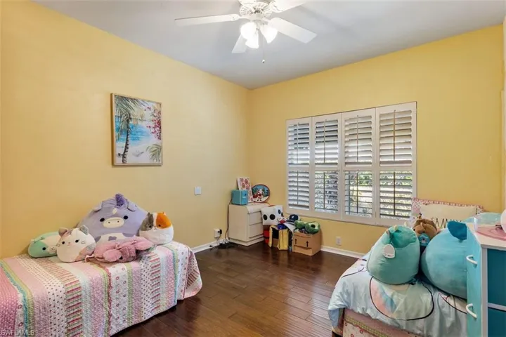 Bedroom featuring wood-type flooring and a ceiling fan