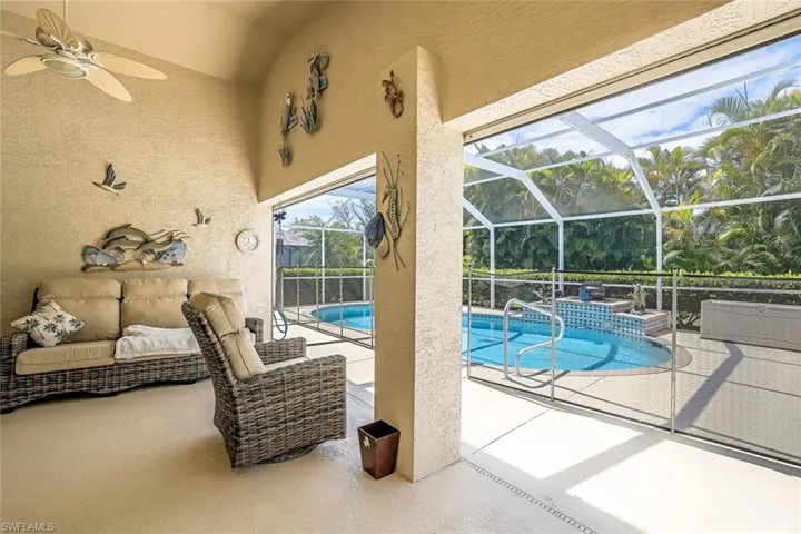 Lanai w/view of swimming pool featuring a lanai, a patio area, and ceiling fan